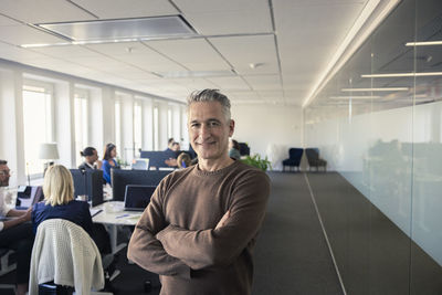 Portrait of team leader standing in office