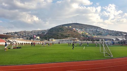 Panoramic view of crowd in park against sky