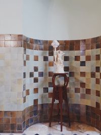 Digital composite image of man standing on tiled floor at home