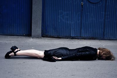 Woman lying down on street