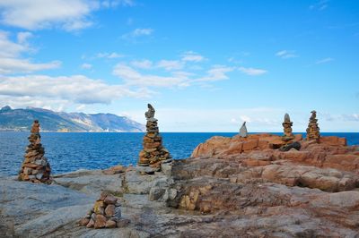 Panoramic view of rocks on beach against sky