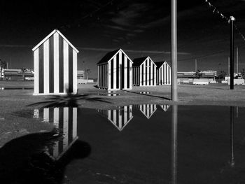 Beach huts reflecting in water