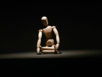 Full length of boy on wood against black background