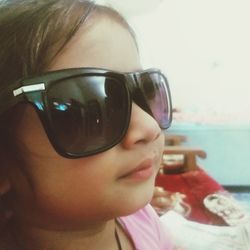 Close-up portrait of girl drinking sunglasses