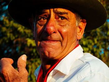 Close-up of man looking away while wearing hat