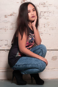 Portrait of young woman sitting on staircase