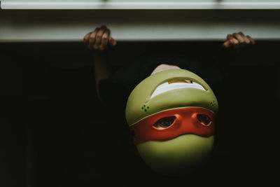 Close-up of boy wearing mask at home