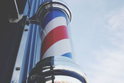 Low angle view of flag against blue sky