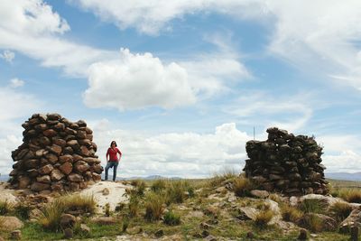 Stack of man standing on field against sky