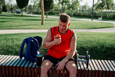 Man sitting on bench in park