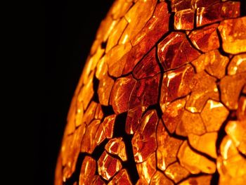 Cropped image of illuminated wax burner in darkroom