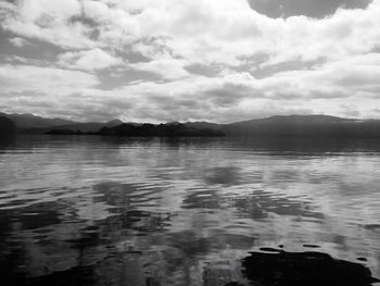 Scenic view of lake against cloudy sky