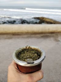 Close-up of person holding ice cream on beach