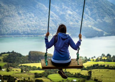 Boy swinging at playground