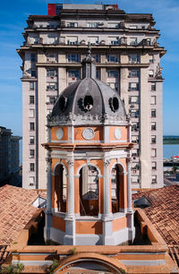 Built structure by sea against sky