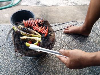 High angle view of people on barbecue grill