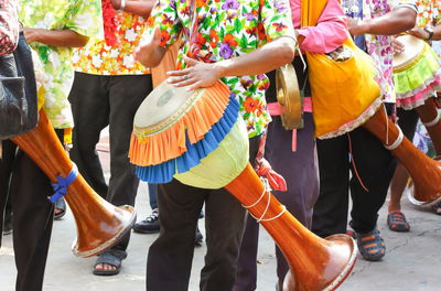 Low section of people dancing on street in city
