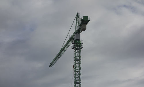 Construction crane in building industry, heavy machine at construction site