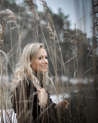 Portrait of smiling young woman with plants