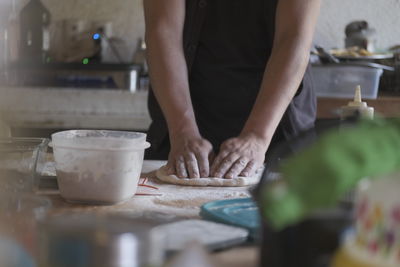 Midsection of man preparing food on table