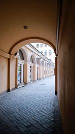Empty alley amidst buildings in city