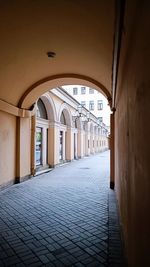 Empty alley amidst buildings in city