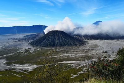 Smoke emitting from volcanic mountain against sky