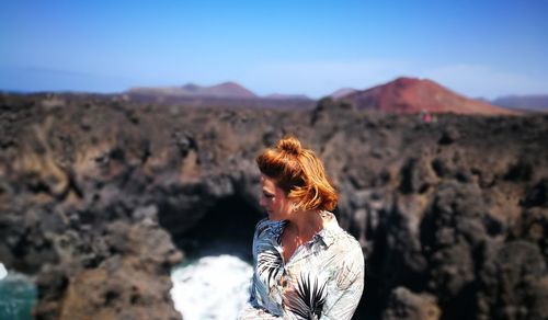 Woman standing against mountains