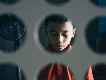 Close-up of young man behind a white partition