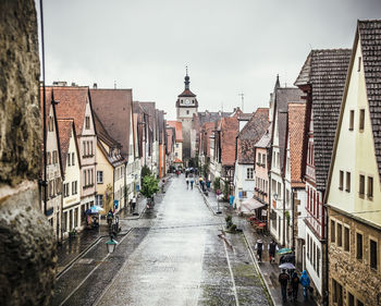 Street amidst buildings in town against sky