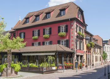 Houses by street in town against sky