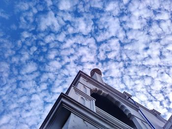 Low angle view of building against cloudy sky