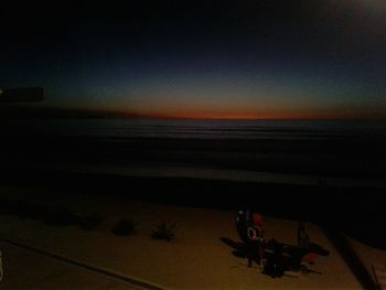 Close-up of beach against sky during sunset