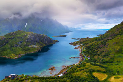 Scenic view of sea and mountains against sky