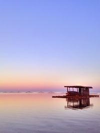 Scenic view of sea against clear sky at sunset