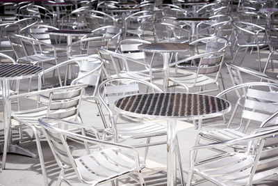 Background of aluminium tables and chairs set up at an outdoor event