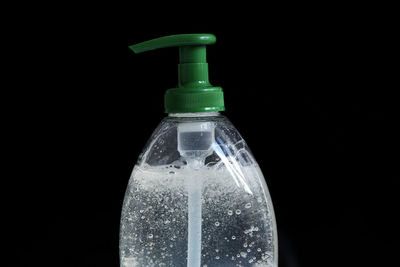 Close-up of water bottle against black background