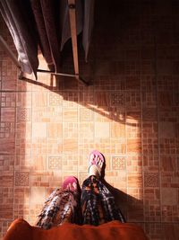 Portrait of woman standing against wall