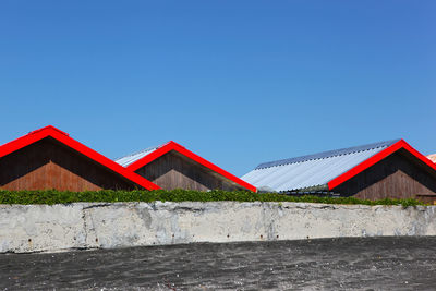 Red house against clear blue sky