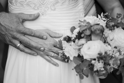 Midsection of woman holding flower bouquet