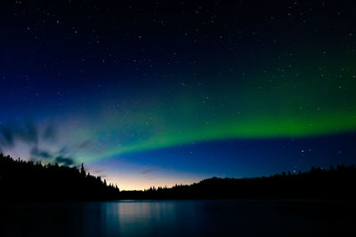 Scenic view of lake against sky at night