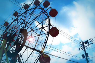 Low angle view of ferris wheel against sky