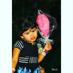 Close-up of baby girl holding umbrella