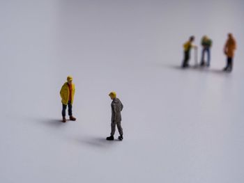 Group of people walking on snow over white background