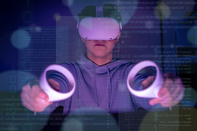 Boy using a virtual reality headset. augmented reality, future technology concept. tech background