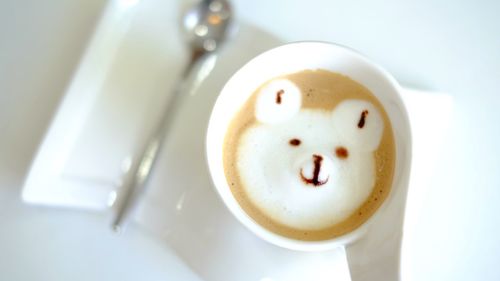 Directly above shot of bear shape in coffee cup on table