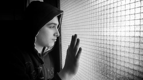 Close-up of boy looking out window