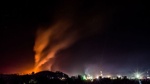 Panoramic view of illuminated buildings against sky at night