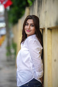 Portrait of young woman standing outdoors