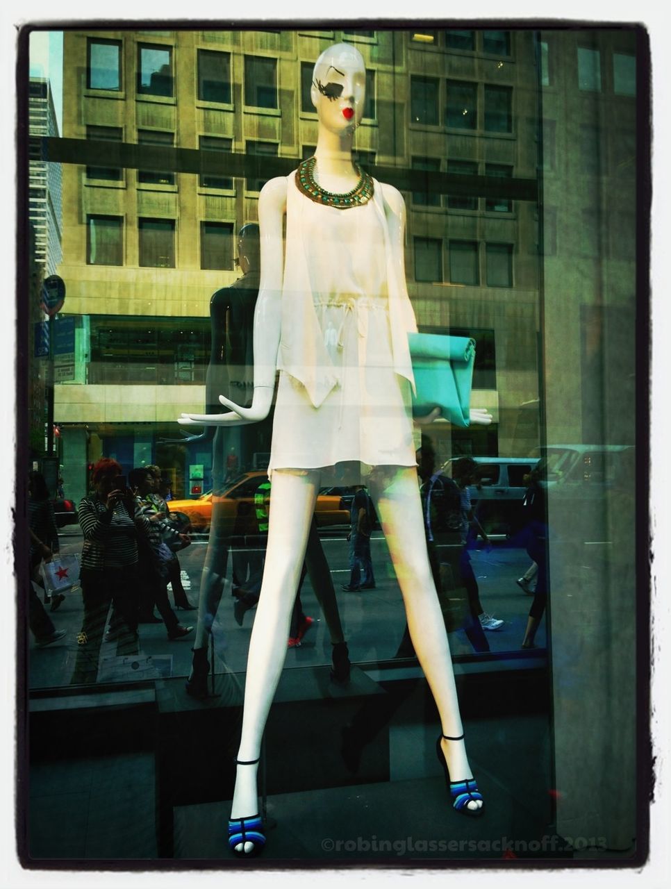 WOMAN STANDING IN FRONT OF BUILDING